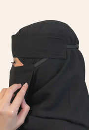 نقاب أسود جانبي بتصميم عملي وخامة ناعمة مع خلفية بلون F9F0EB 